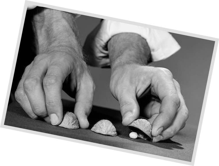 846-06112436 © ClassicStock / Masterfile Model Release: Yes Property Release: No 1960s MAN'S HANDS WITH SHIRT SLEEVES ROLLED UP PLAYING SHELL GAME 